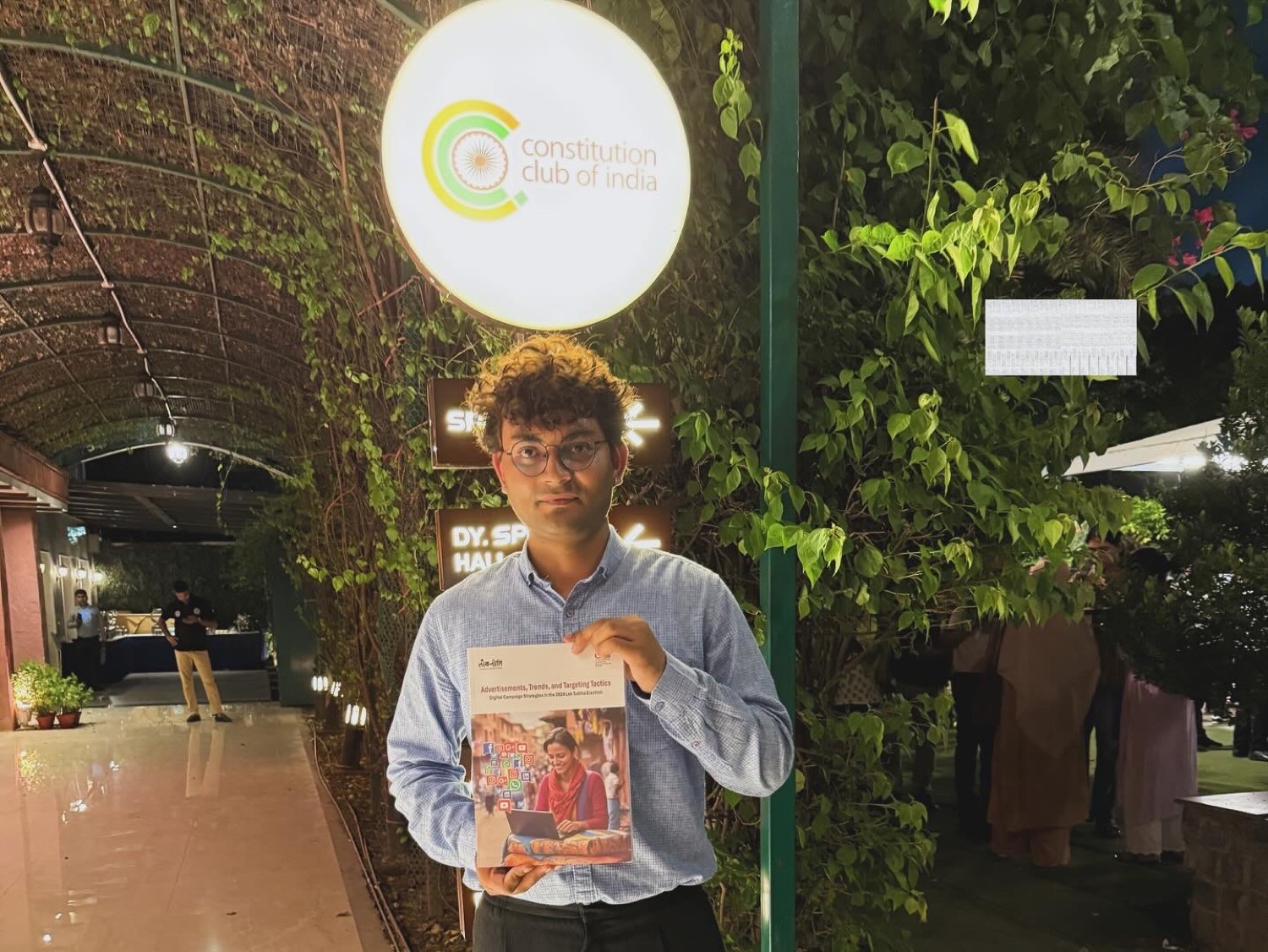 Abhishek Sharma holding the CSDS digital campaign report at Constitution Club of India